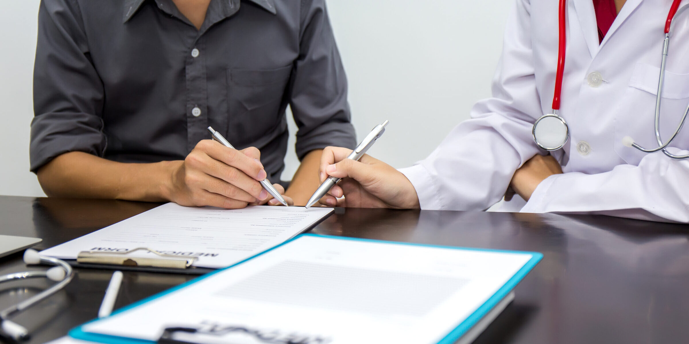 Female doctors and male patients talk about treatment. Counseling and treatment methods. Signing a license surgery